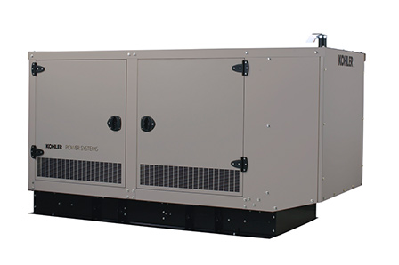 A large, rectangular, beige Kohler industrial generator with vented panels and double doors, featuring D2 Energy technology, sits on a black base against a plain white background.