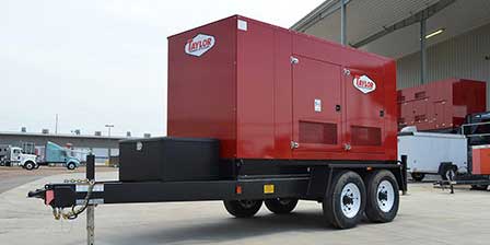 A large red mobile generator on a black trailer with dual wheels, parked outdoors near a building and other equipment, highlights the quality of Largo's generator services with its logo displayed prominently on the sides.